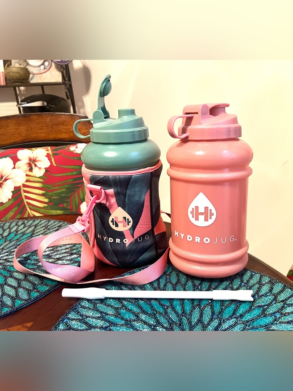 One green and one peach 73 oz Hydro Jug, limited edition tropical sleeve & straw